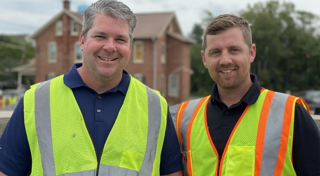 Two construction workers at job site