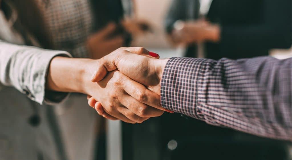 Man and woman shake hands