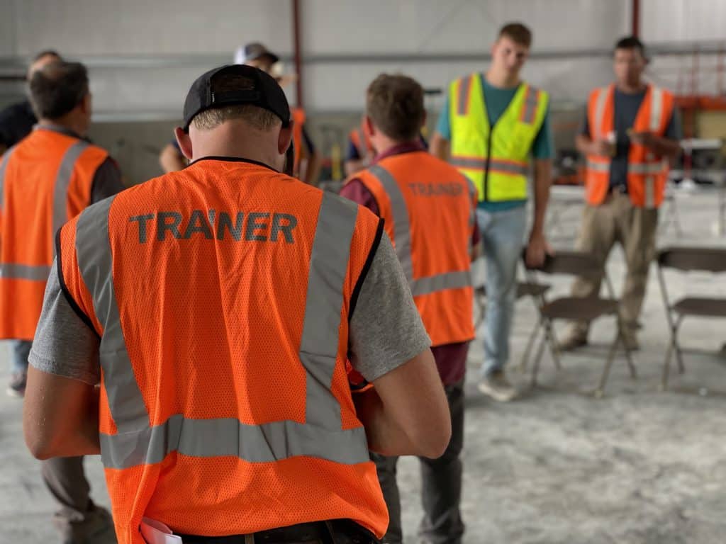 Trainer wearing a vest on job site