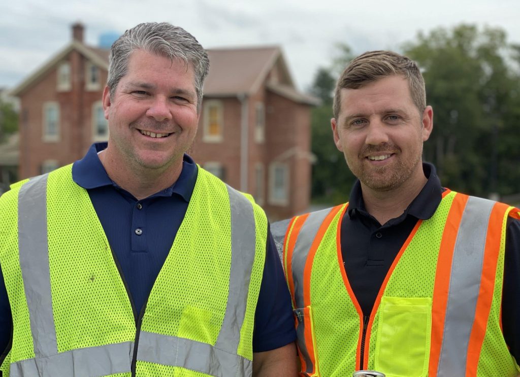 Two installers wearing vests